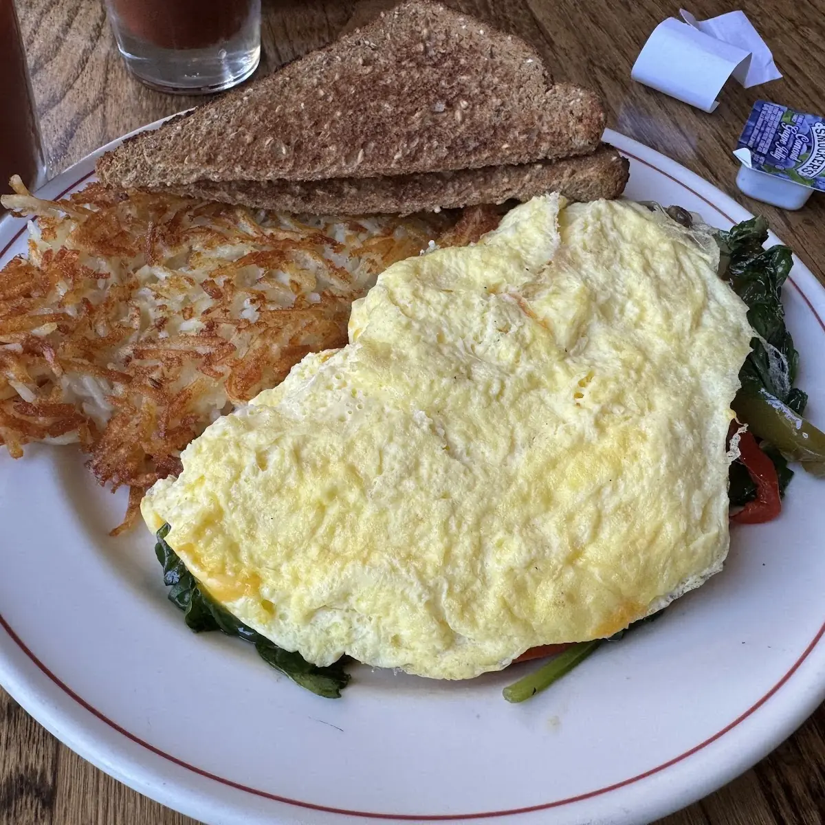 Omelet with Hash Browns and Syrup