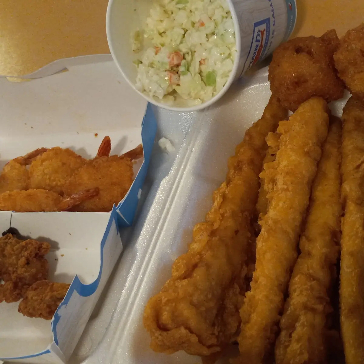 Pollock Filets Hushpuppies Fried Oysters Fried Butterfly Shrimp and Coleslaw