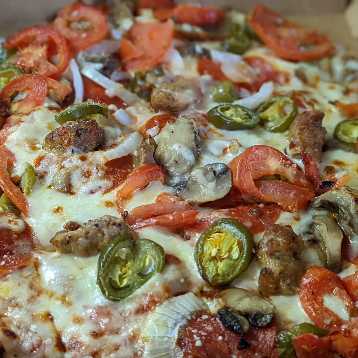 Thin Crust Deluxe Pizza with Tomatoes Jalapenos