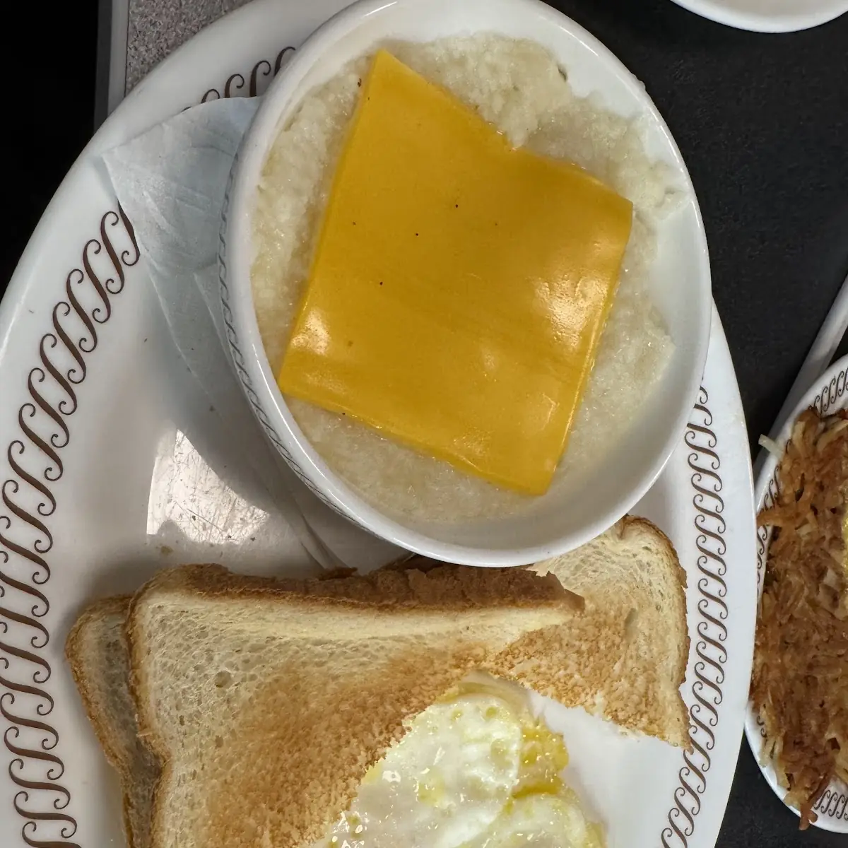 Cheese Grits with Eggs over Medium and Buttered Toast