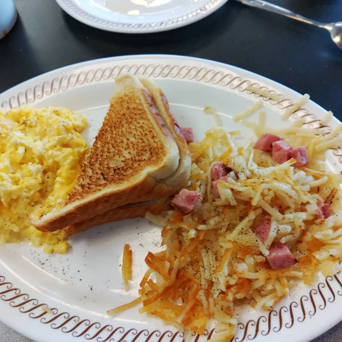 Two Scrambled Eggs and Hash Browns Bacon or Sausage