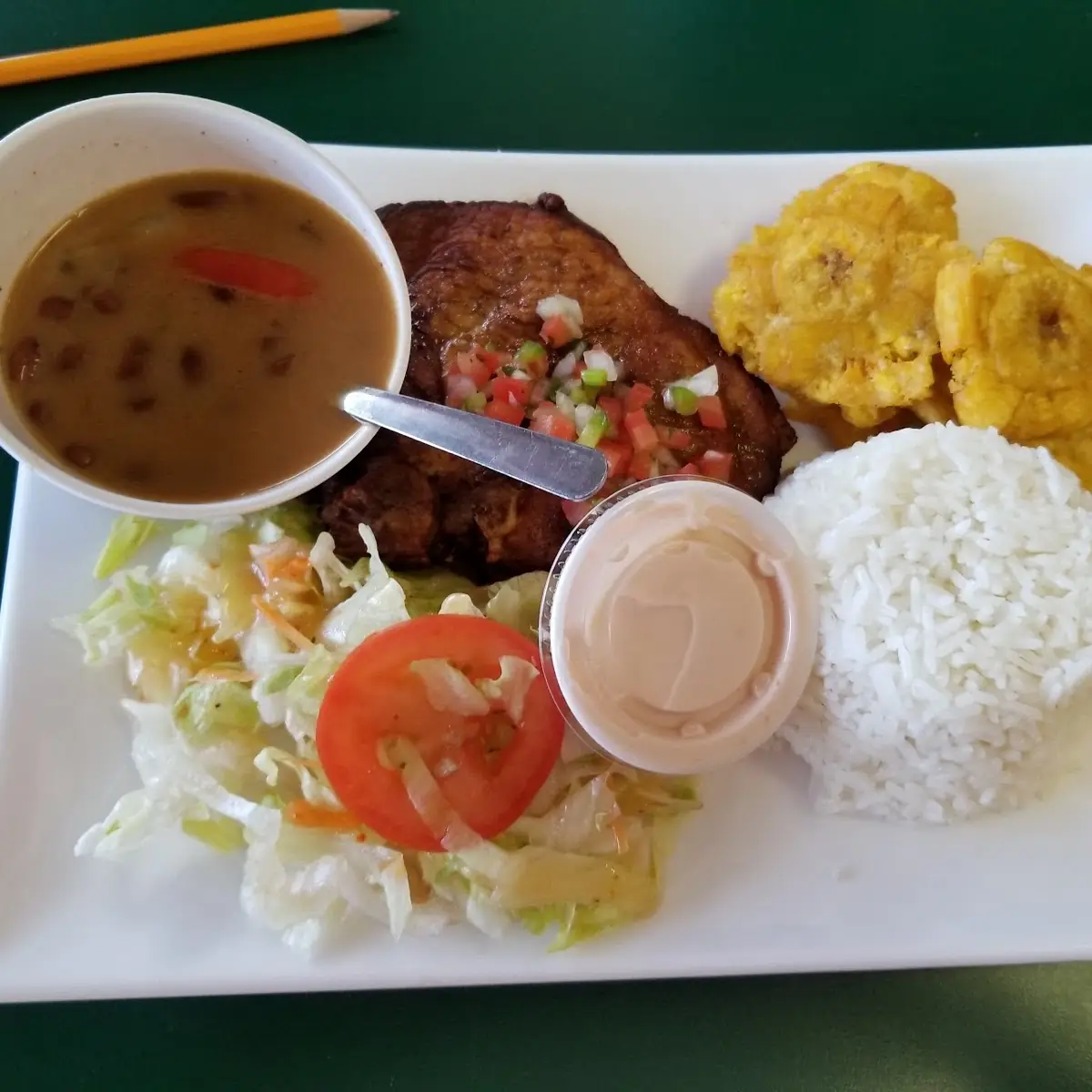 Chuleta Frita with Tostones White Rice Beans Y Salad