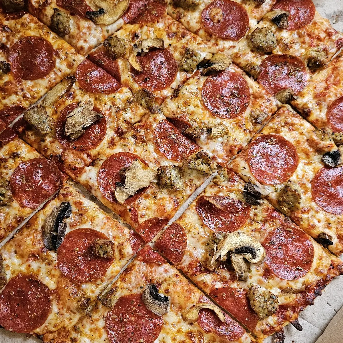 Thin Crust Pepperoni and Sausage Pizza with Mushrooms