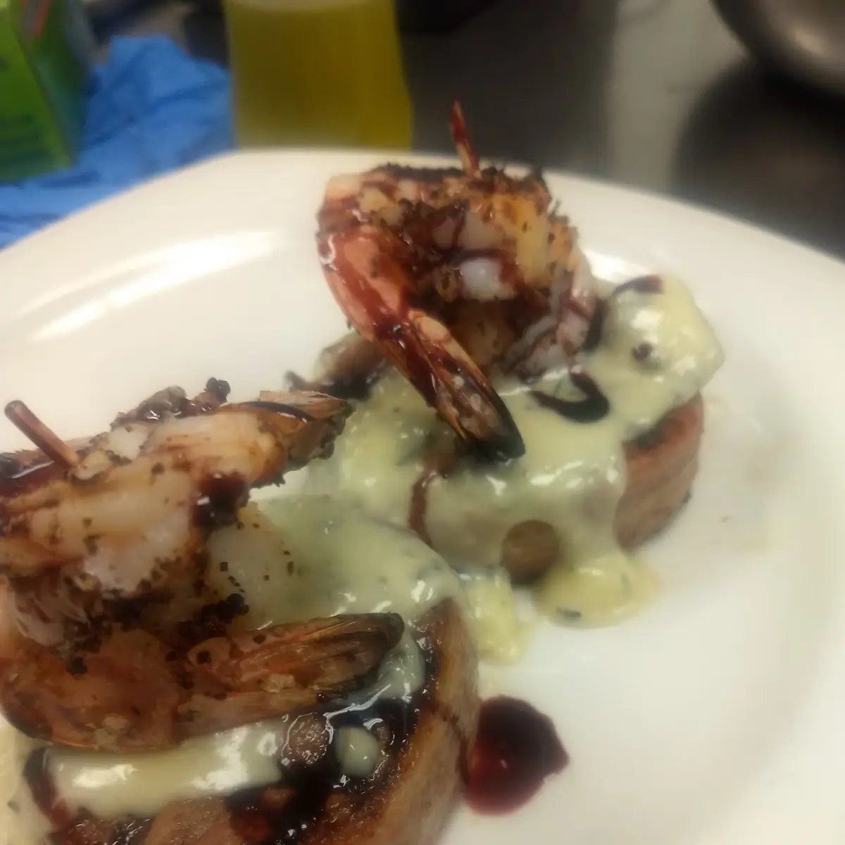 Bacon Wrapped Beef Medellin with a Bluecheese Cream Sauce Grilled Shrimp and a Pinot Reduction