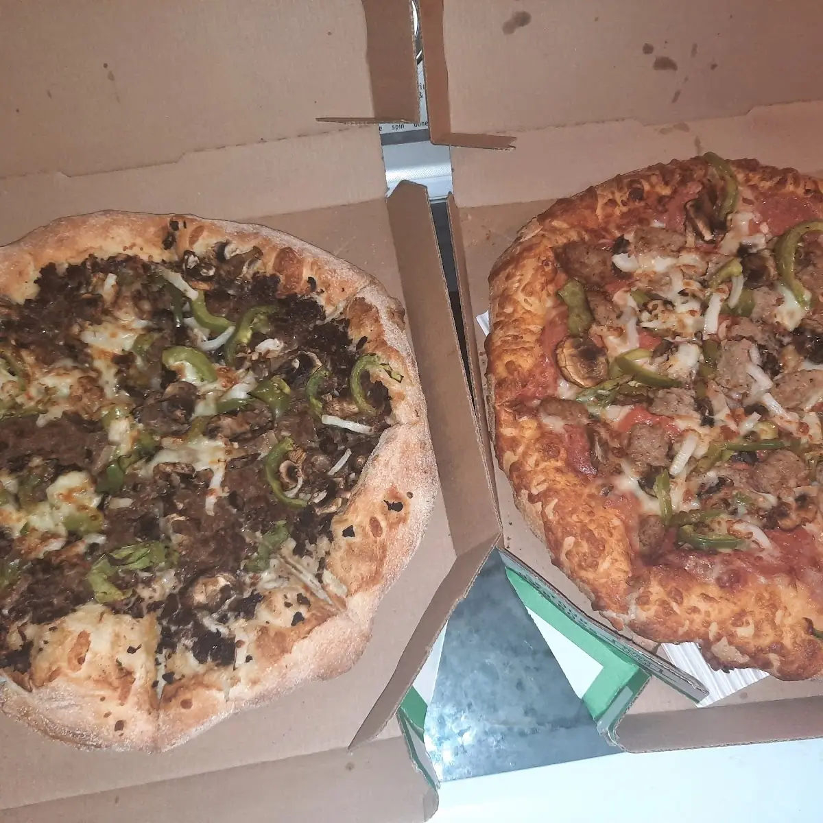 Philly Cheesesteak Pizza Left Deluxe Pizza Right
