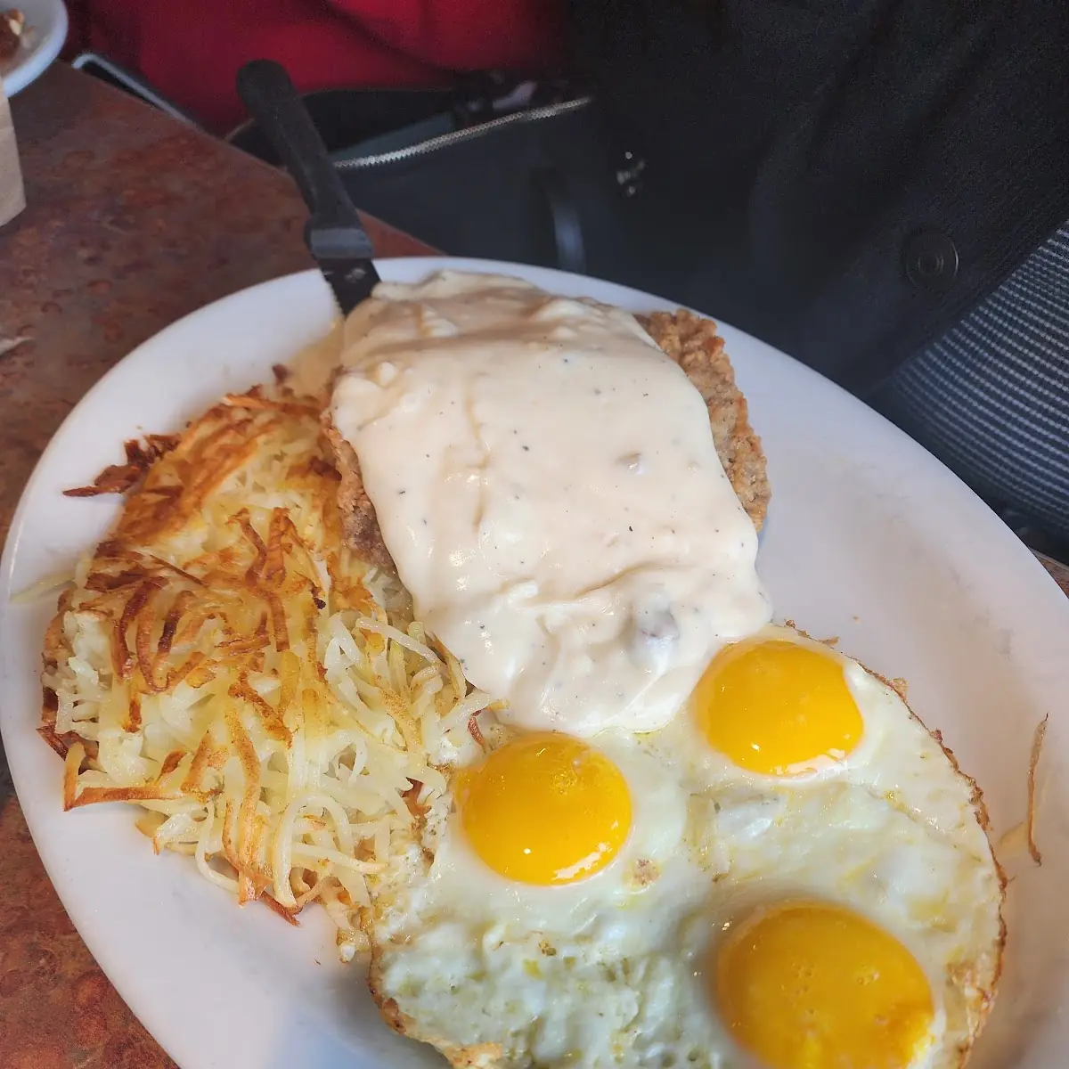 Chicken Fried Steak over Easy Scramble Eggs with Hash Brown