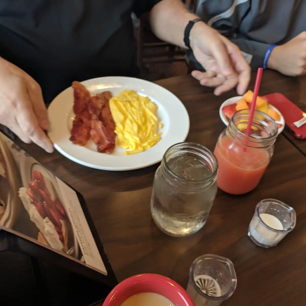 Bacon Eggs Fruit and Cranberry and Orange Juice