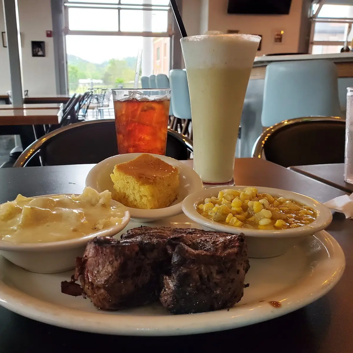 Steak with Cornbread Fried Corn Mashed Potatoes with Gravy and a Pina Colada with Tea