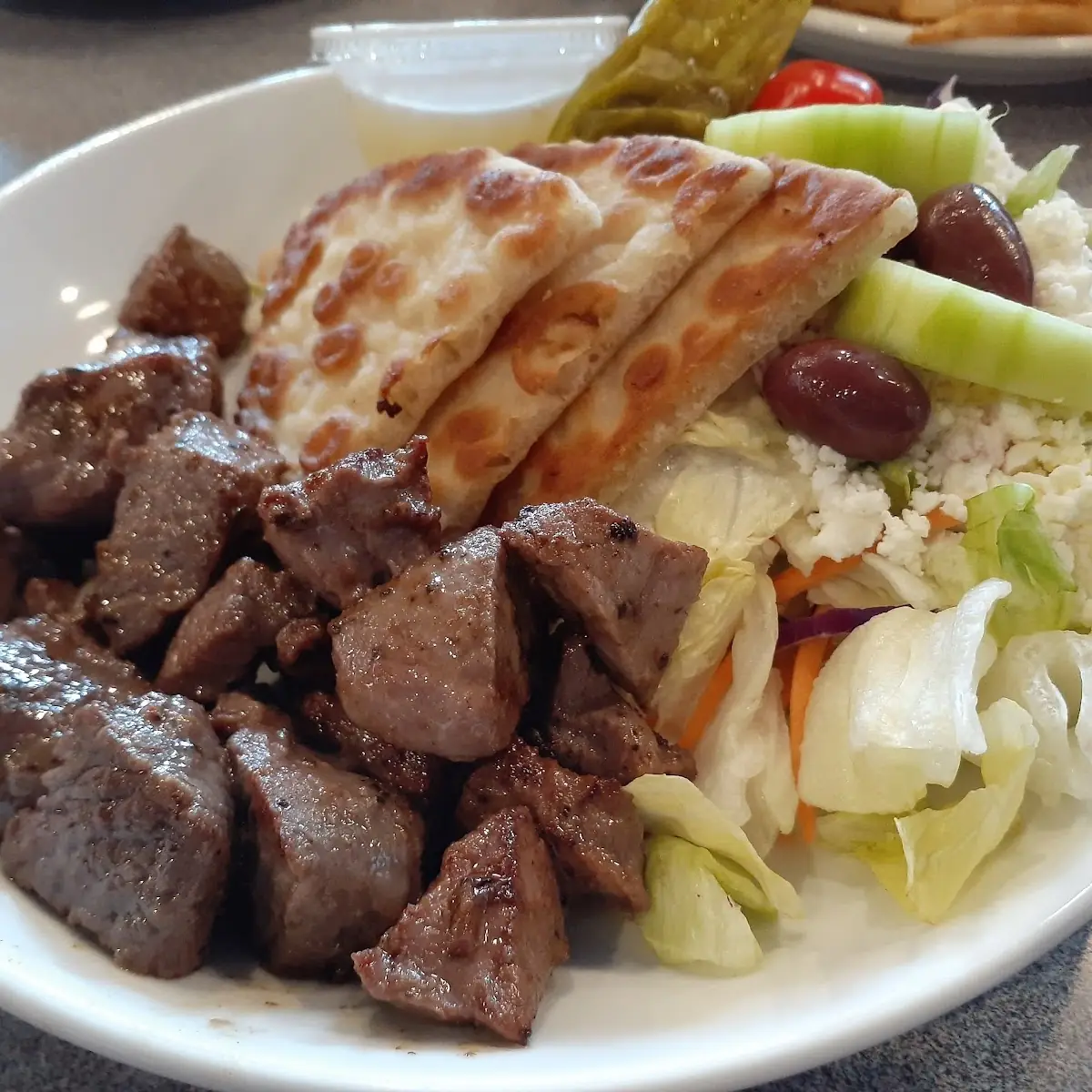 Marinated Beef Tips with Greek Salad and Pita Bread