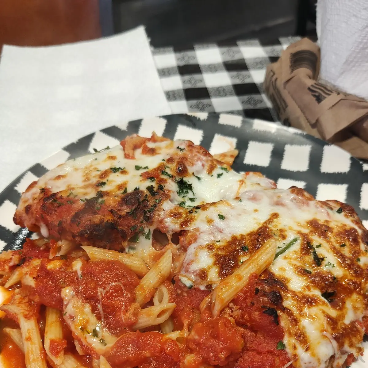 Chicken Parmigiana Served over Penne Pasta