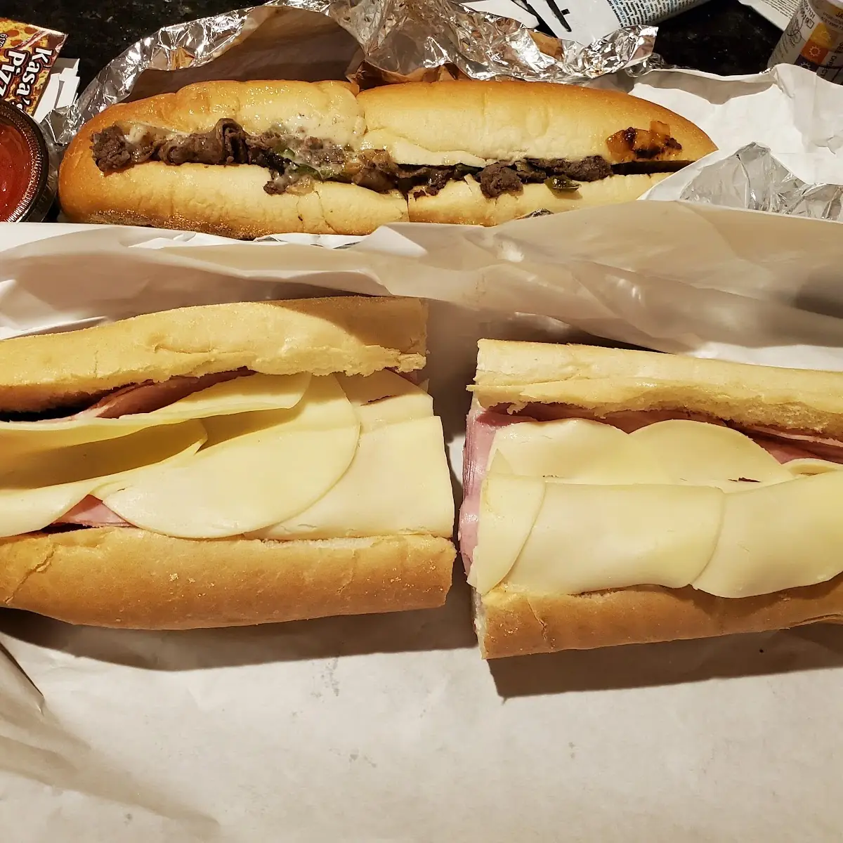 Cheesesteak Sandwich with Sauce and Ham and Cheese Sandwich