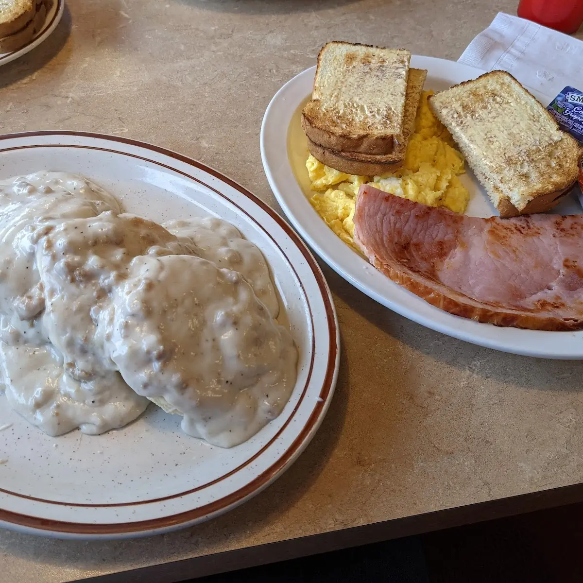 Biscuits and Sausage Gravy with Side of Ham Scrambled Eggs and Sourdough Toast