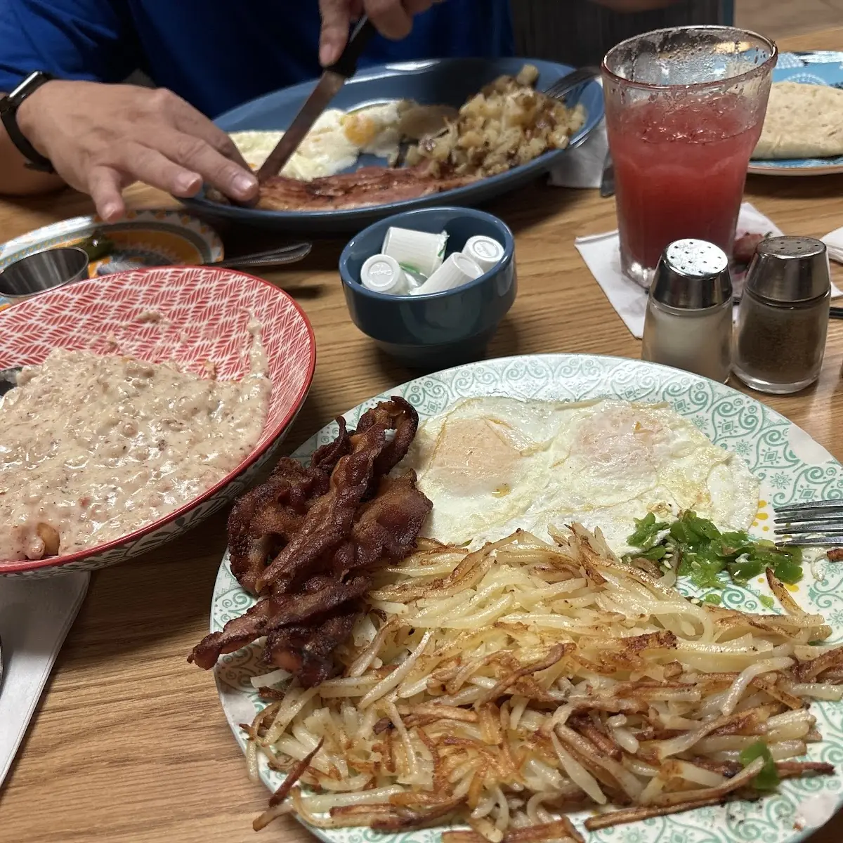 Three Eggs and Meat Platter with Ground Beef Patty Three Eggs over Medium on Top of My Hashbrowns