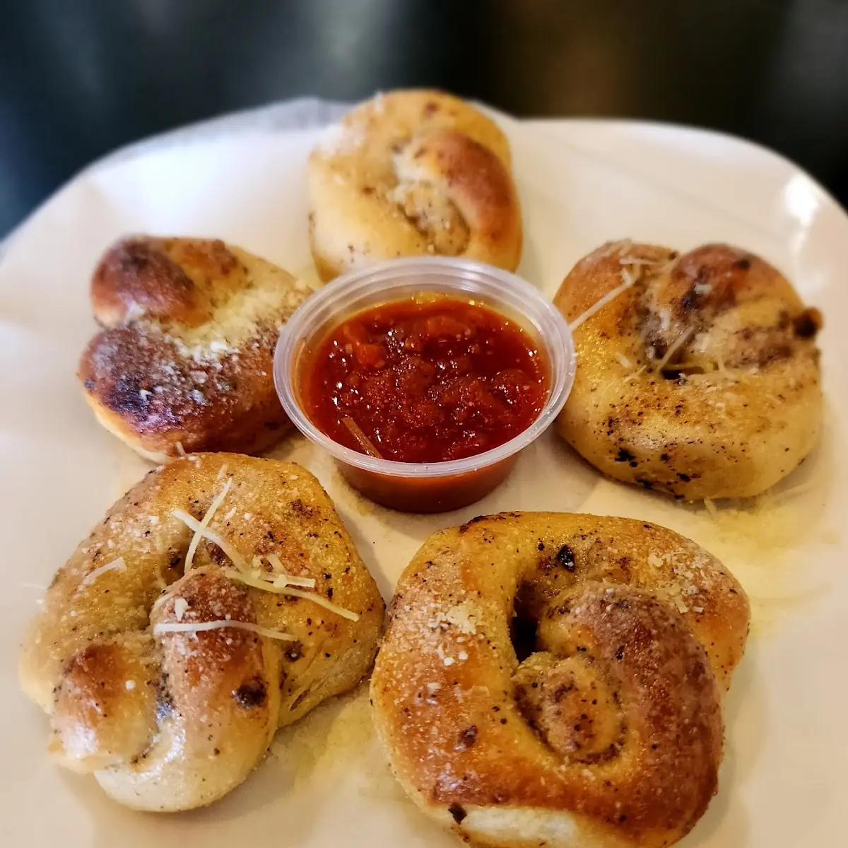 Loaf of Garlic Bread With Cheese and Side of Sauce