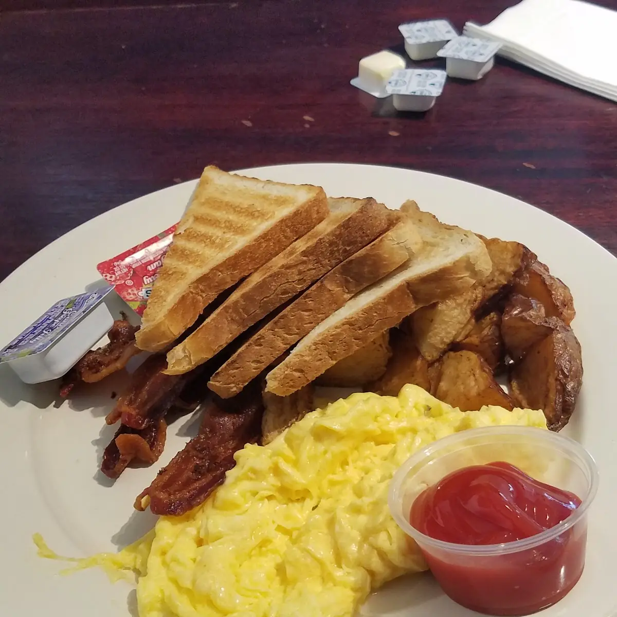 Scrambled Eggs Bacon or Sausage Home Fries and a Biscuit