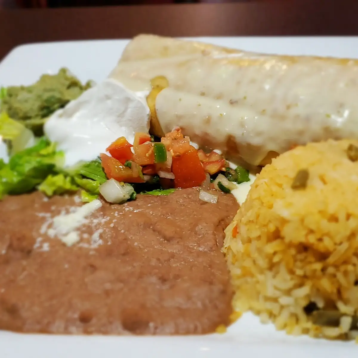 Pollo Con Chorizo with Rice and Refried Beans