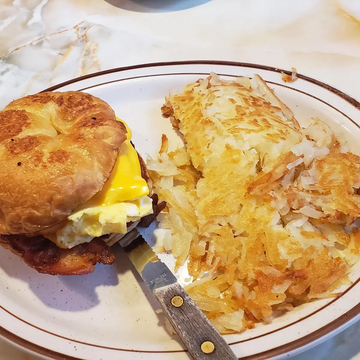 Bacon Egg and Cheese Croissant with Hash Browns