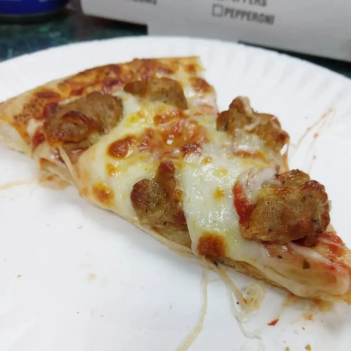 Slice from Medium Regular Crust Sausage Pizza