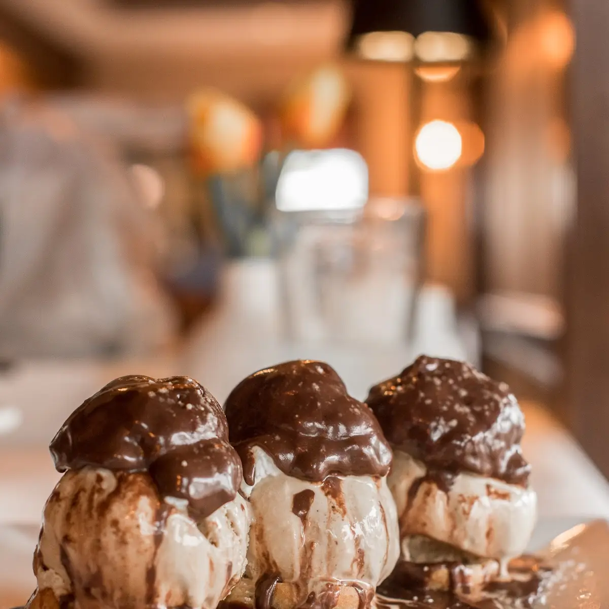Vanilla Ice Cream Profiterols with Chocolate Sauce Toasted Almonds & Whipped Cream