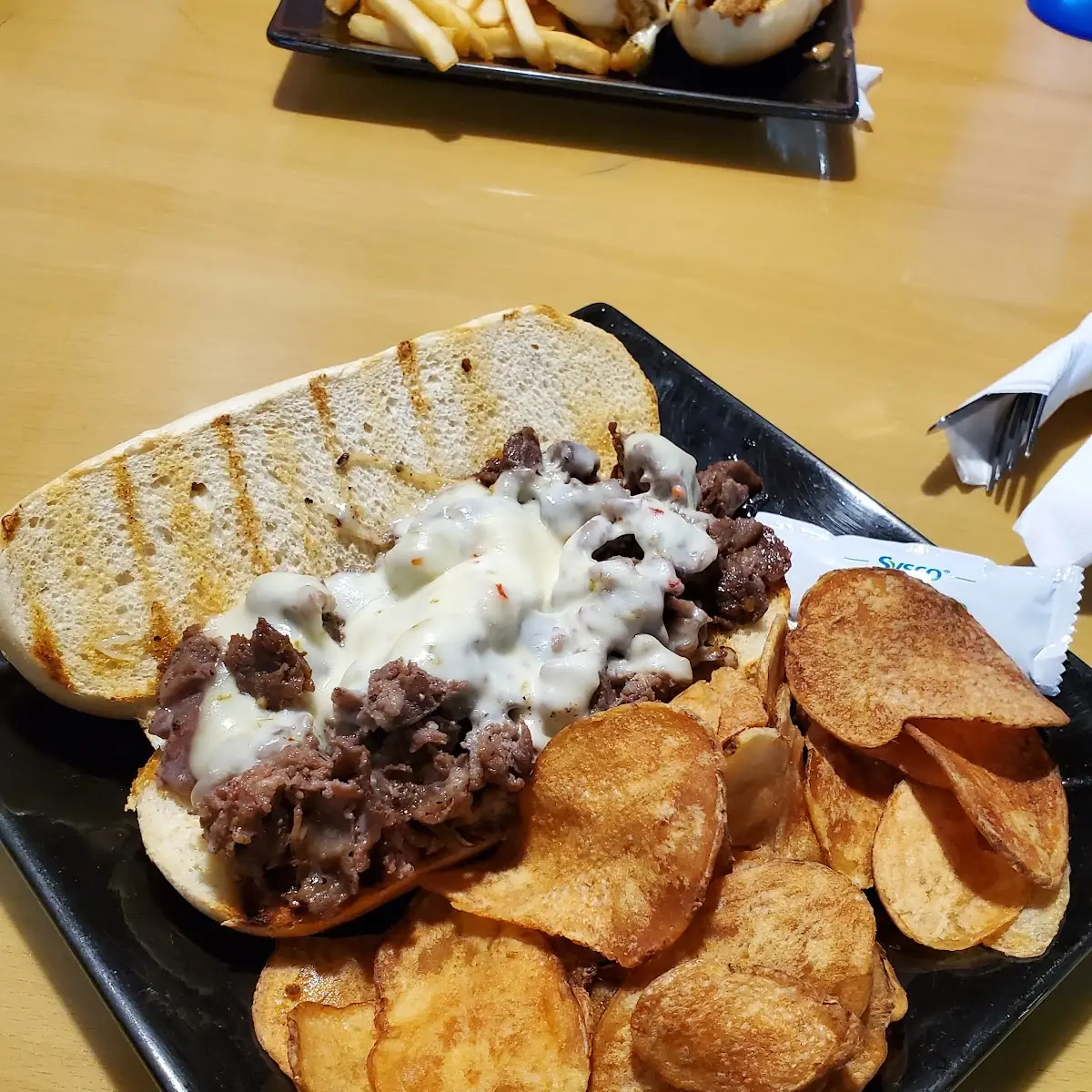 Philly Cheese Steak Sandwich with Pepper Jack Cheese and House Chips