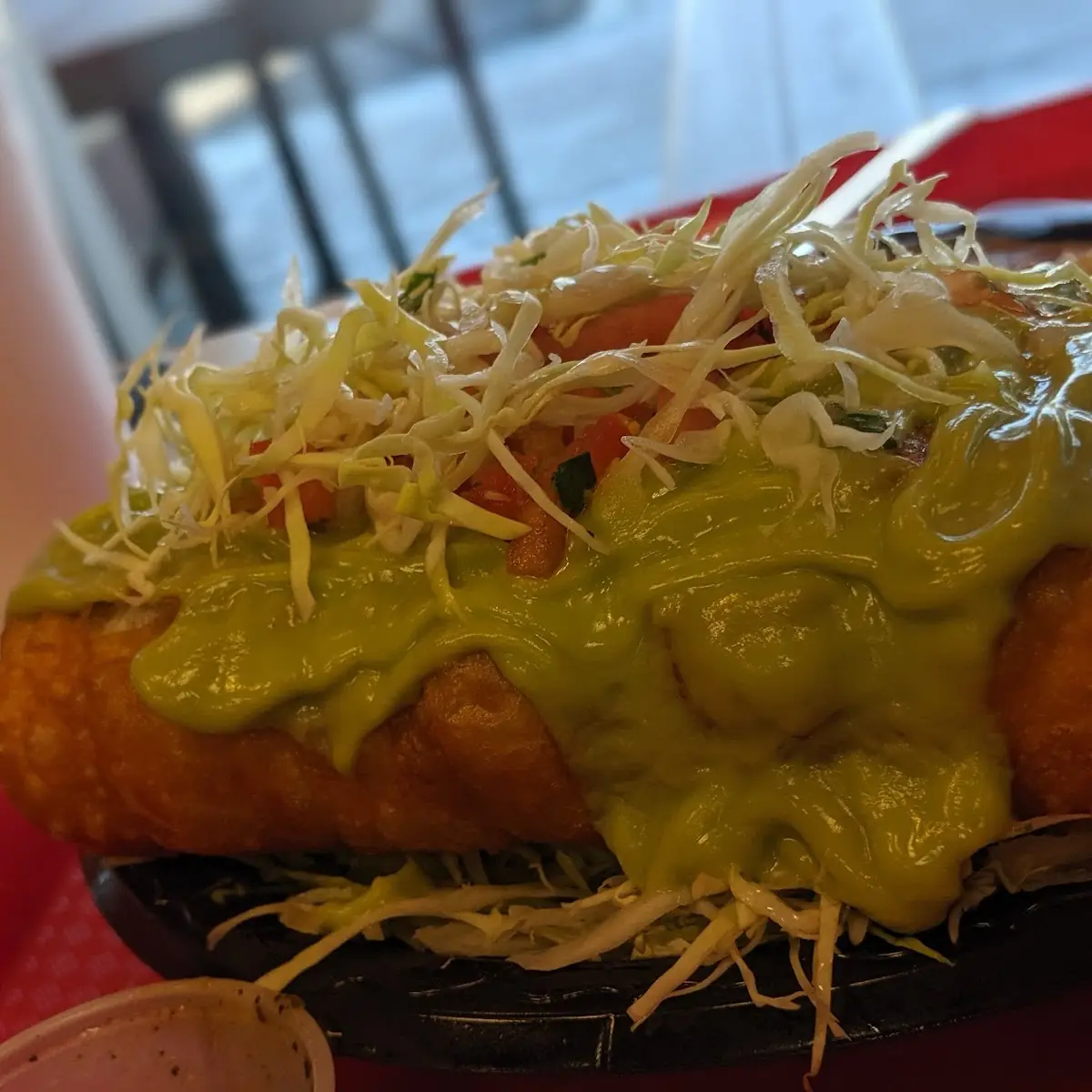 Veggie Chimichanga with Guacamole and Cabbage on Top