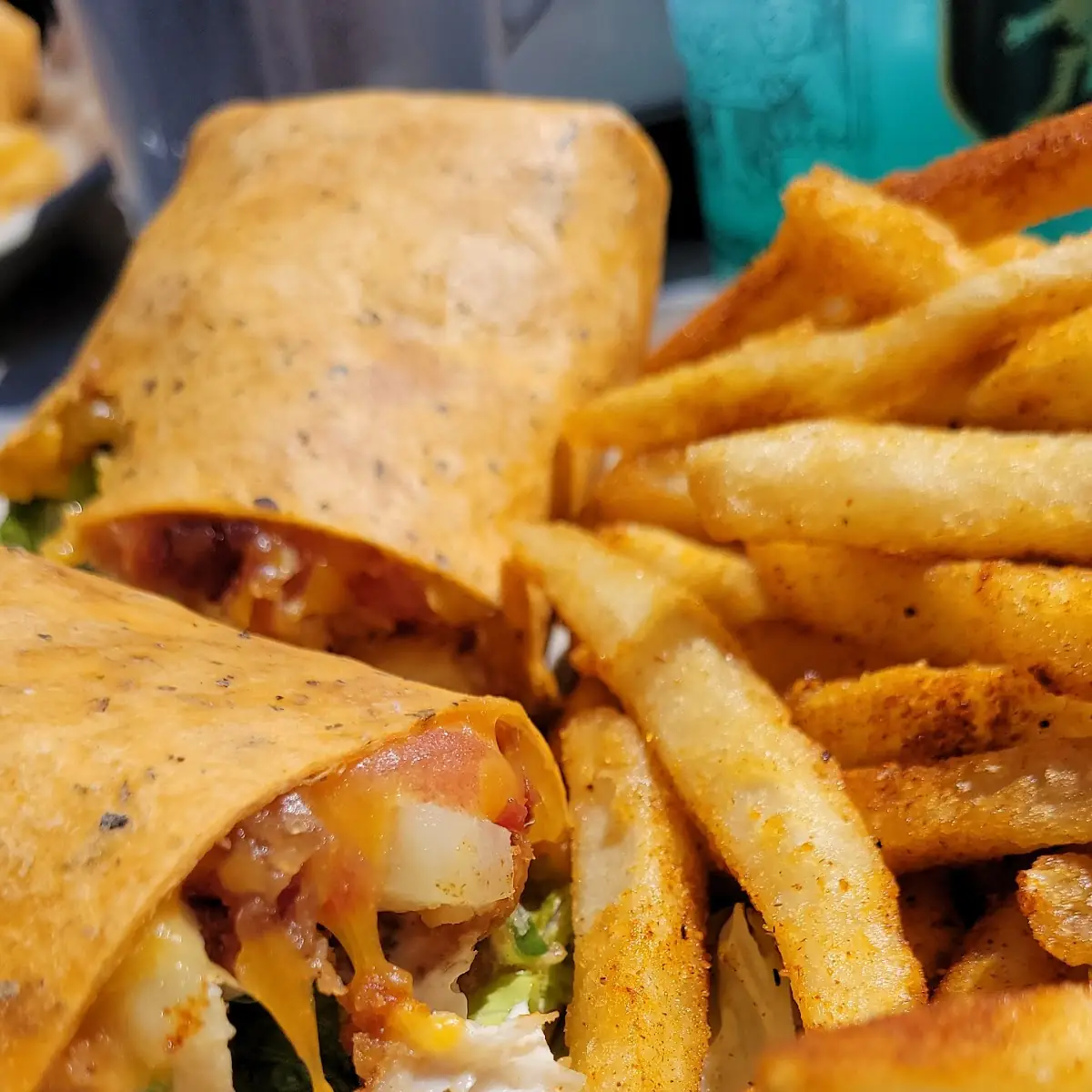 Kevin's Chicken Wrap with Tomato and Cucumber Added and Cajun Fries