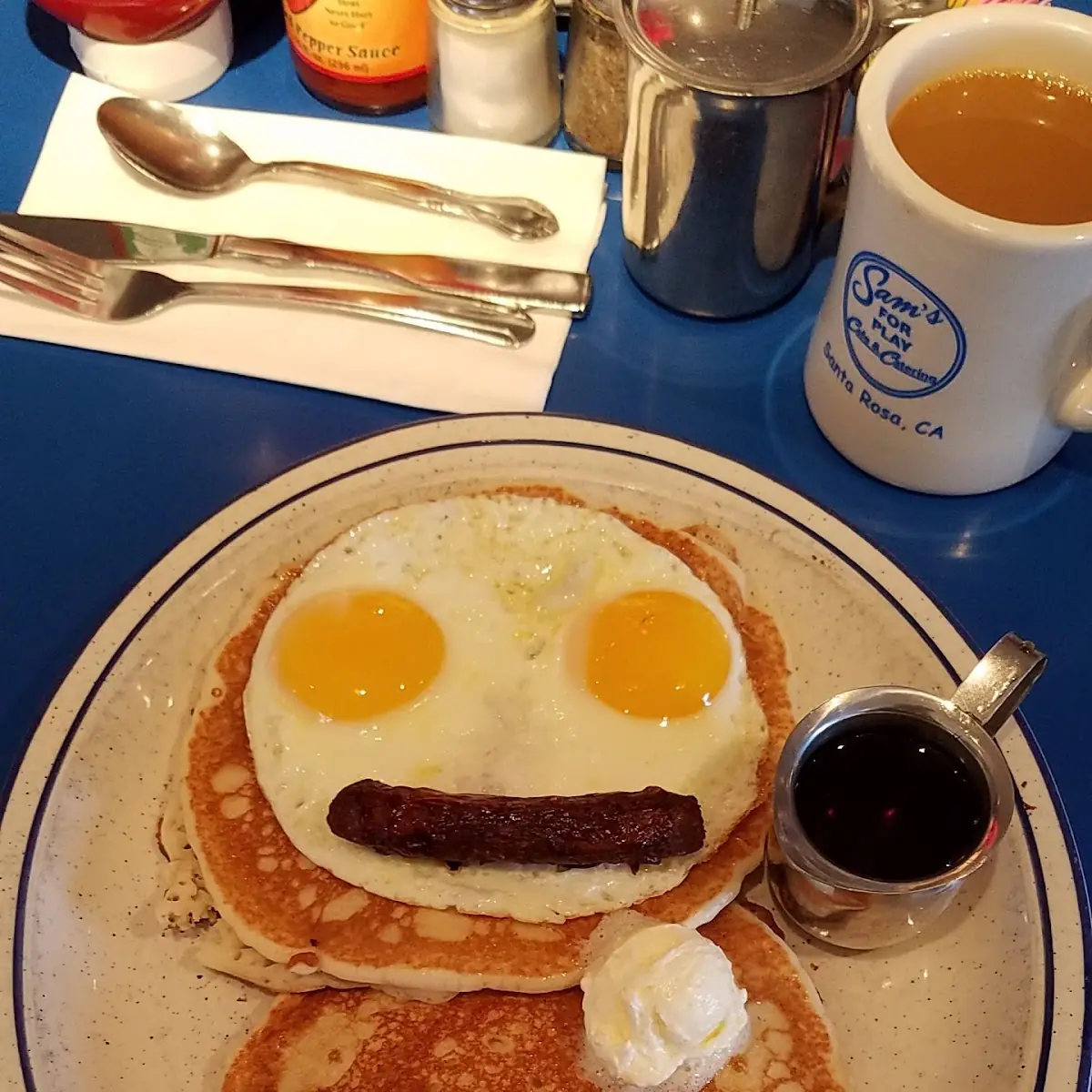 Very Happy Pancake Breakfast with Eggs and Sausage