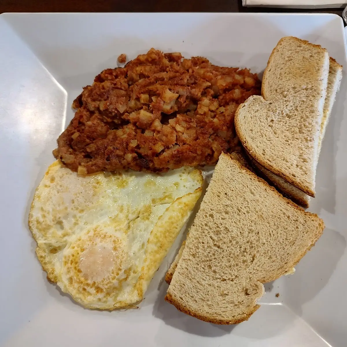 Corned Beef Hash Eggs over Medium and Buttered Wheat Toast