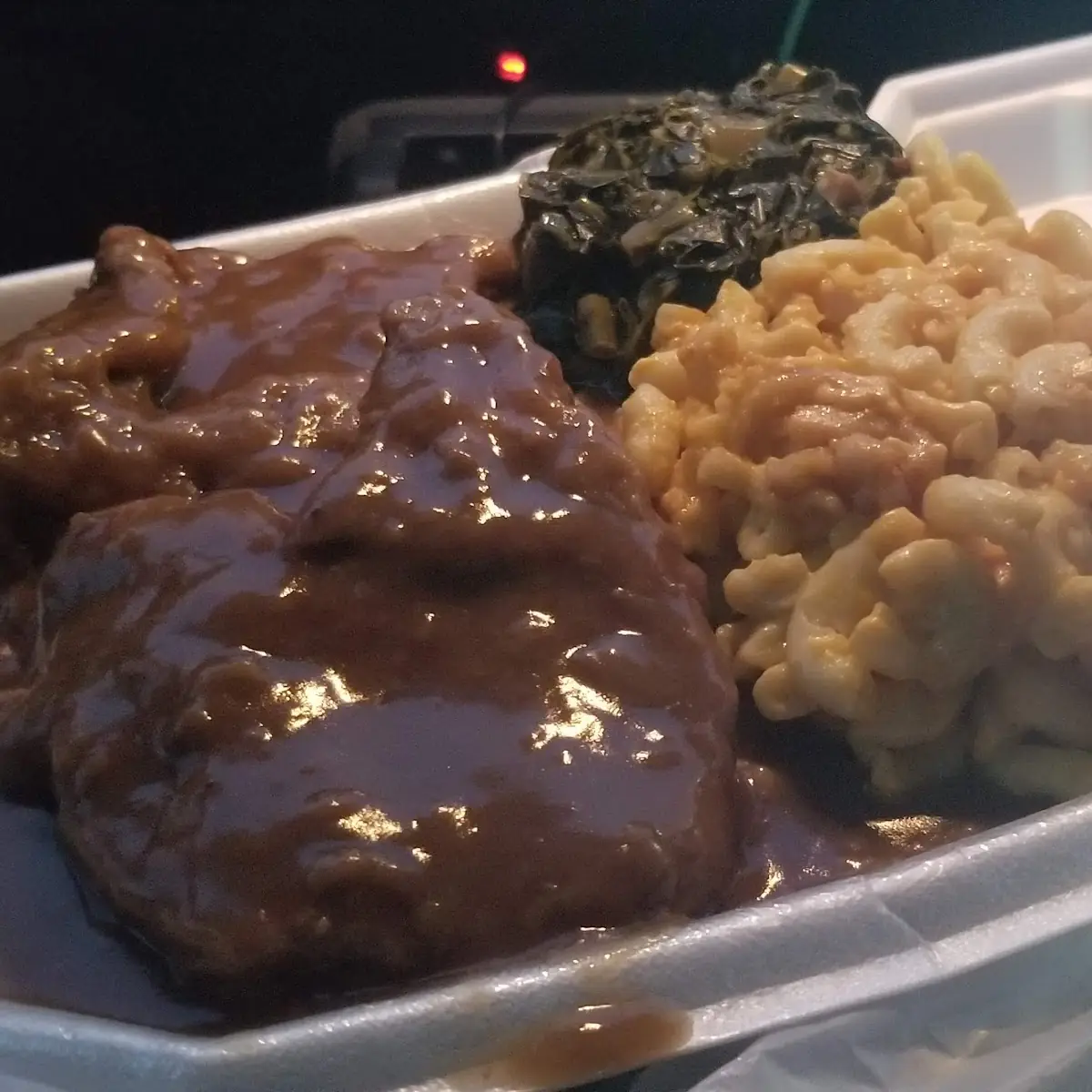 Homestyle Smithered Chops over White Rice & Gravy Mac & Cheese Greens