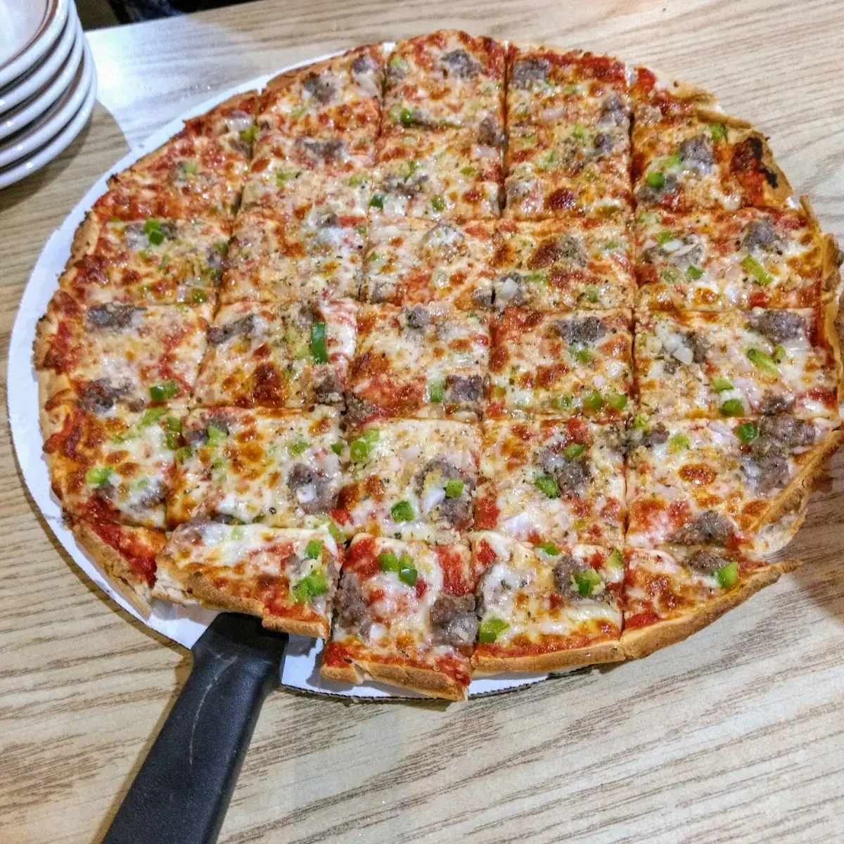 Thin Crust Pizza with Sausage Green Pepper Onion and Garlic