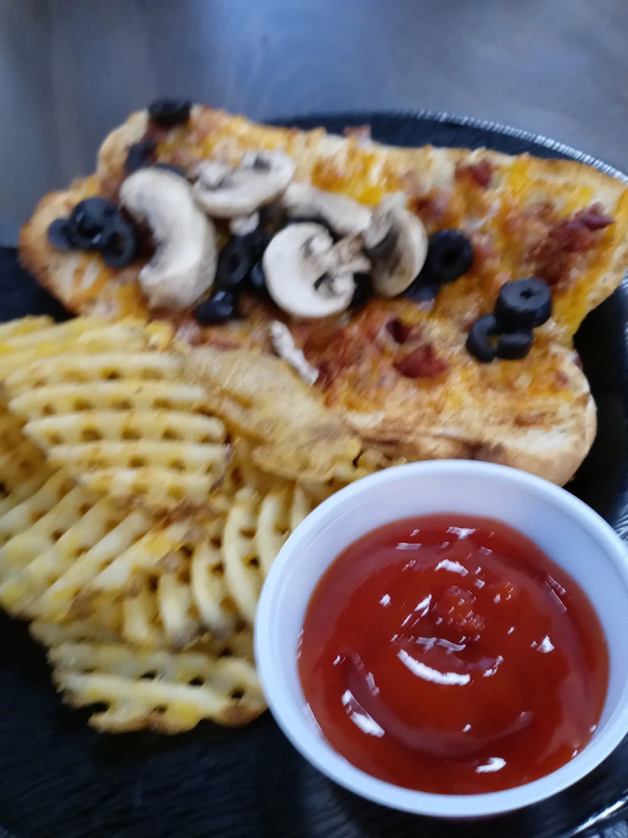 A Sub with Cheese Pepperoni Olives and Mushrooms with Side of Waffle Fries