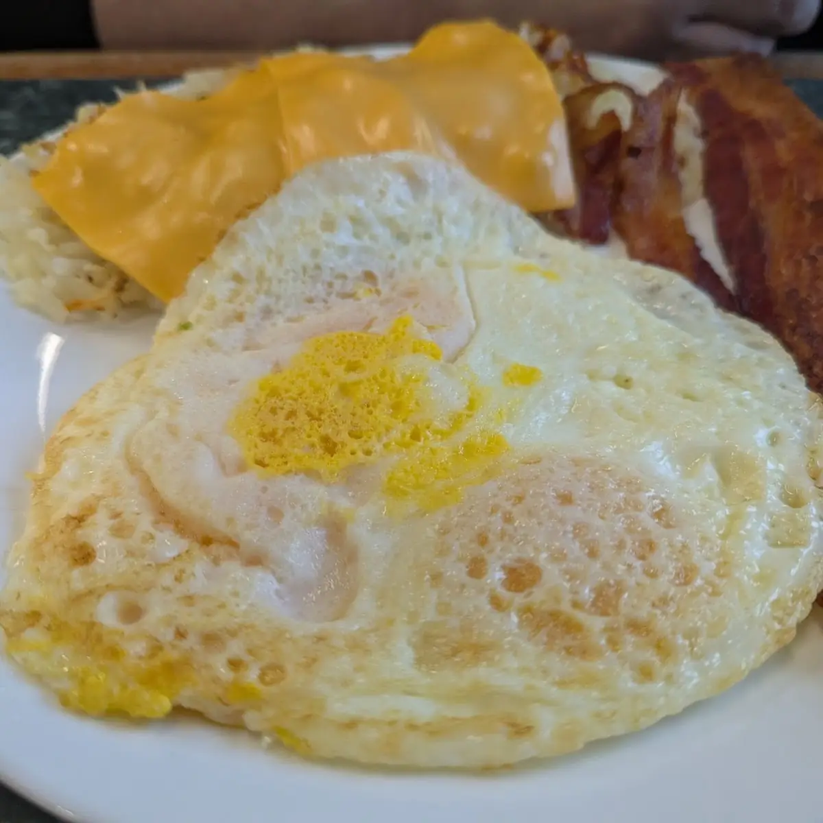 Over Easy Eggs Bacon and Hash Browns
