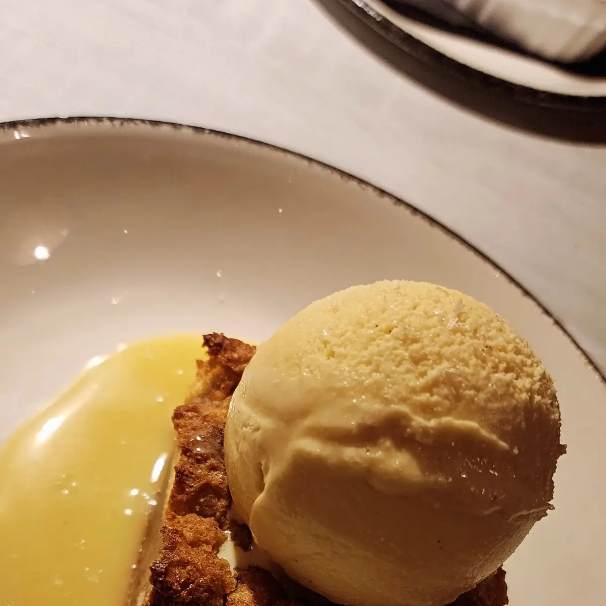 Bread Pudding with Brown Butter Ice Cream and White Chocolate Drizzle