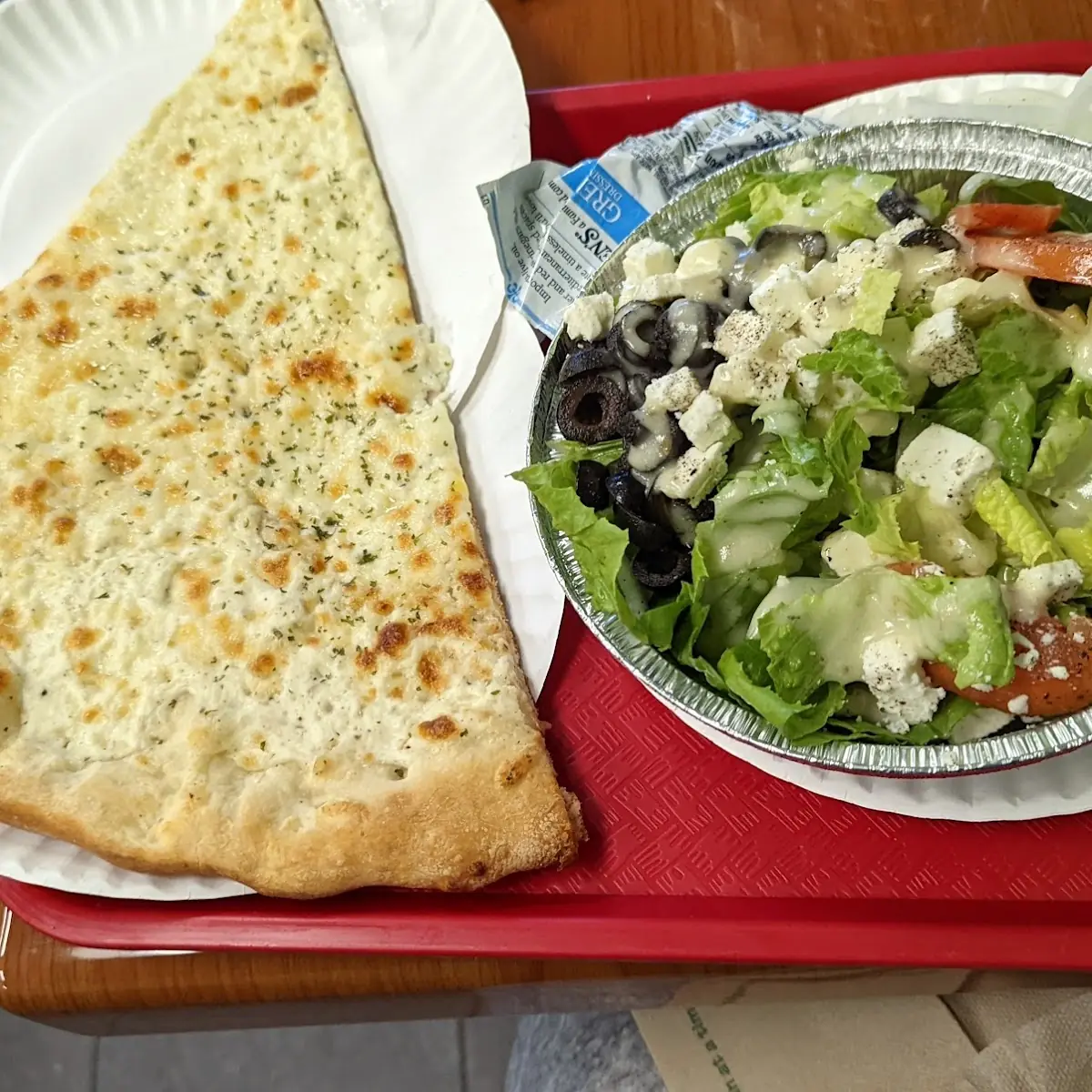 White Pizza Slice with Greek Salad