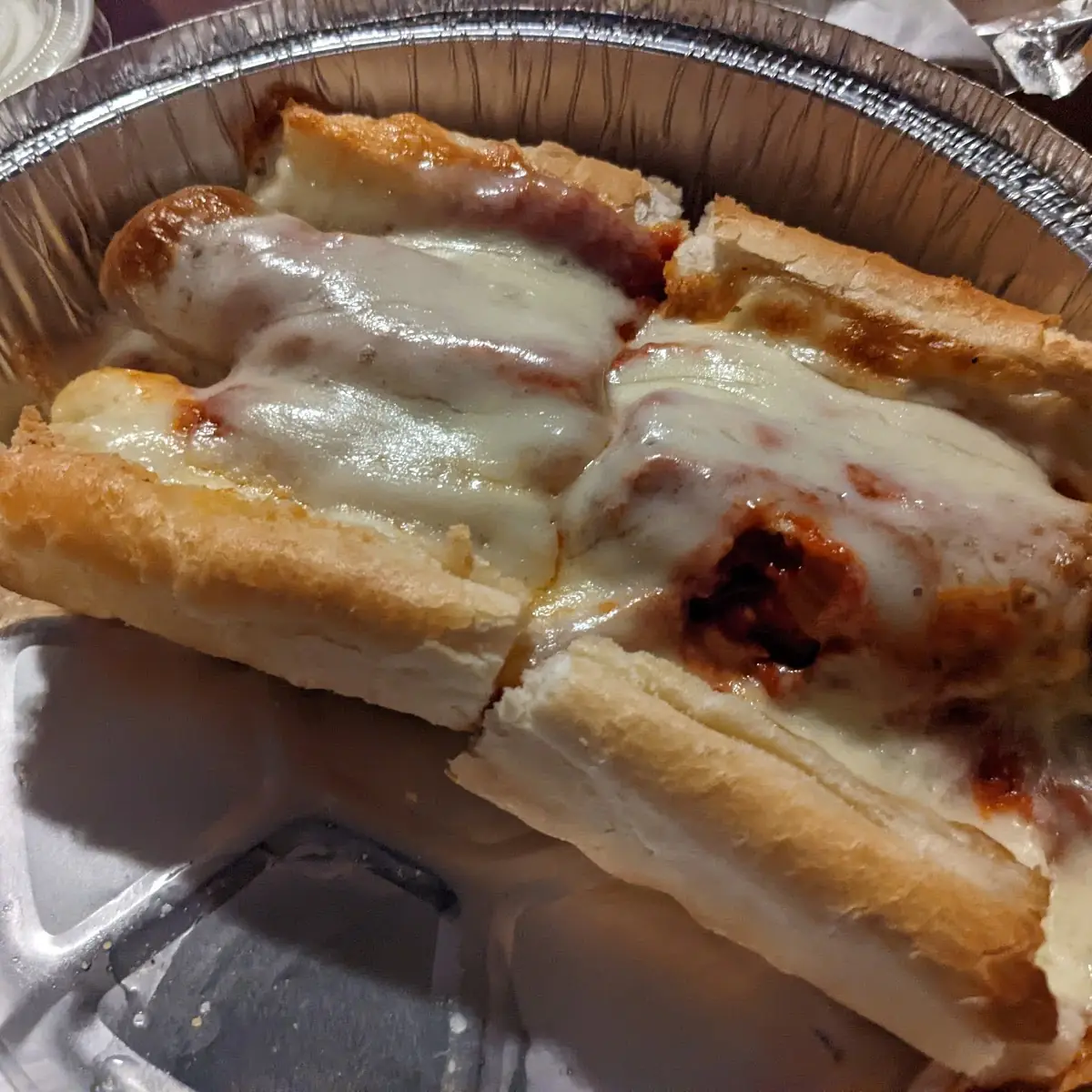 Italian Sausage Sandwich on Garlic Bread with Melted Cheese