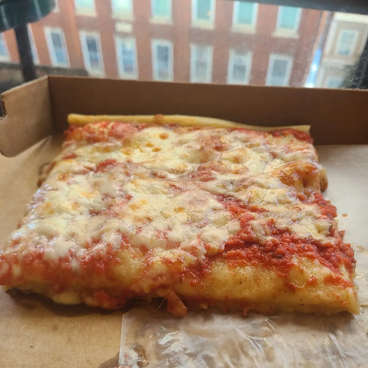 Hot Pizza Slice Served in Store