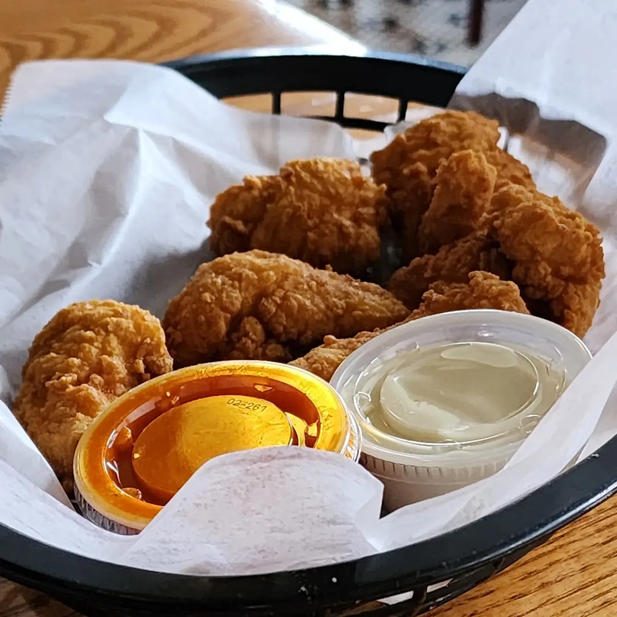 Breaded Plain Boneless Wings with Buffalo Sauce and Blue Cheese on the Side