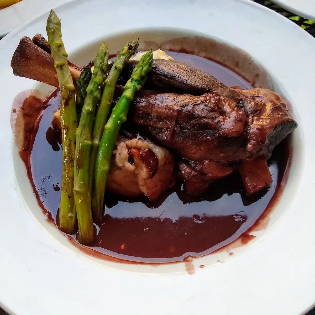 Braised Lamb Shank with Roasted Garlic Champ Grilled Asparagus and a Red Wine Sauce