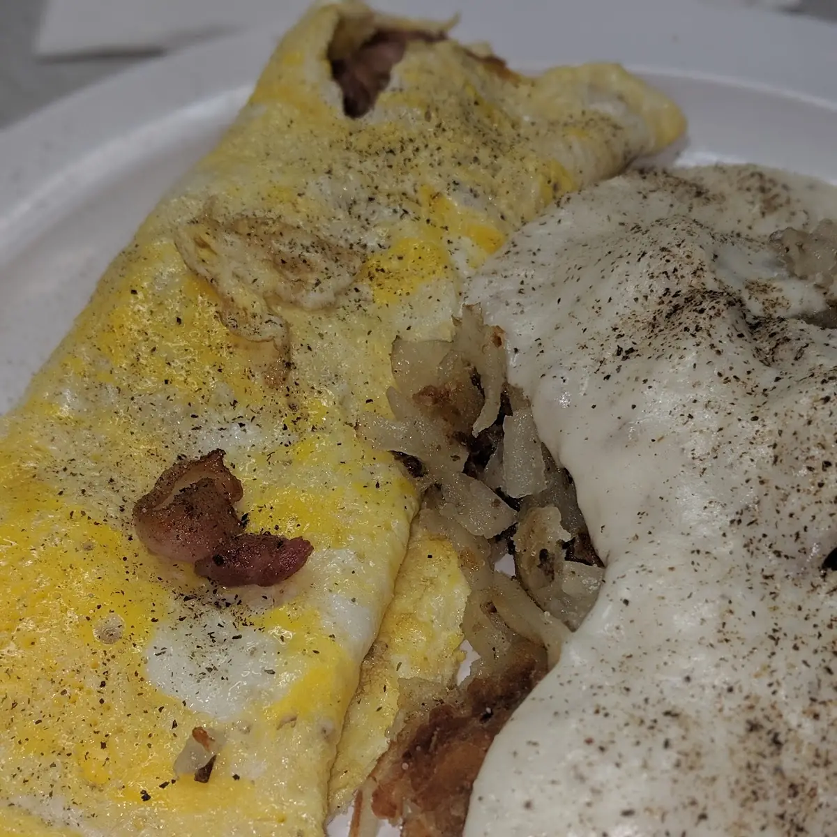 Bacon Egg Cheese Omelet with a Side of Hashbrowns and Gravy