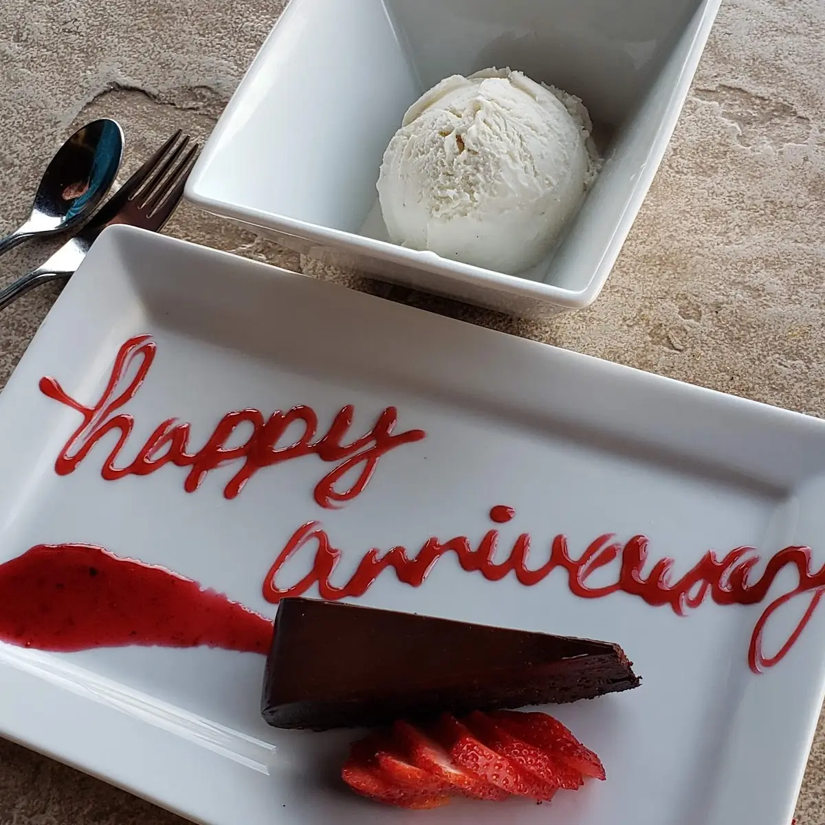 Flourless Chocolate Cake with Raspberry Sauce and Vanilla Bean Ice Cream