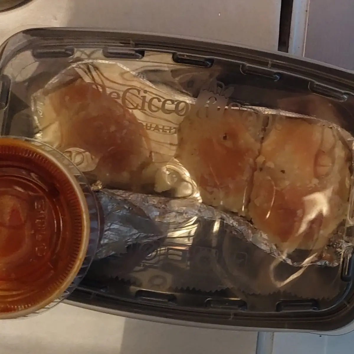 These Are Leftover Garlic Knots in Another Stores Plastic Container Used for Storage