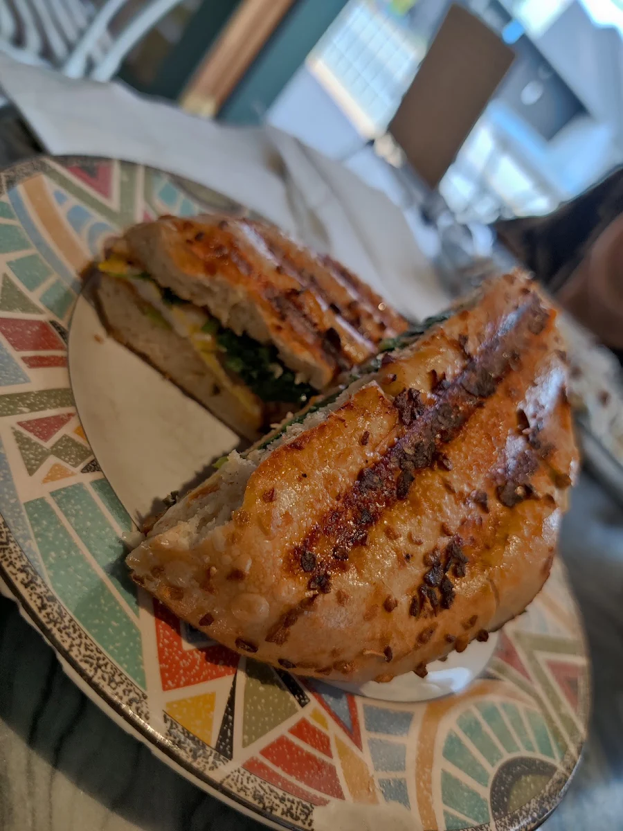 Eggs Tomatoes and Spinach on a Bagel