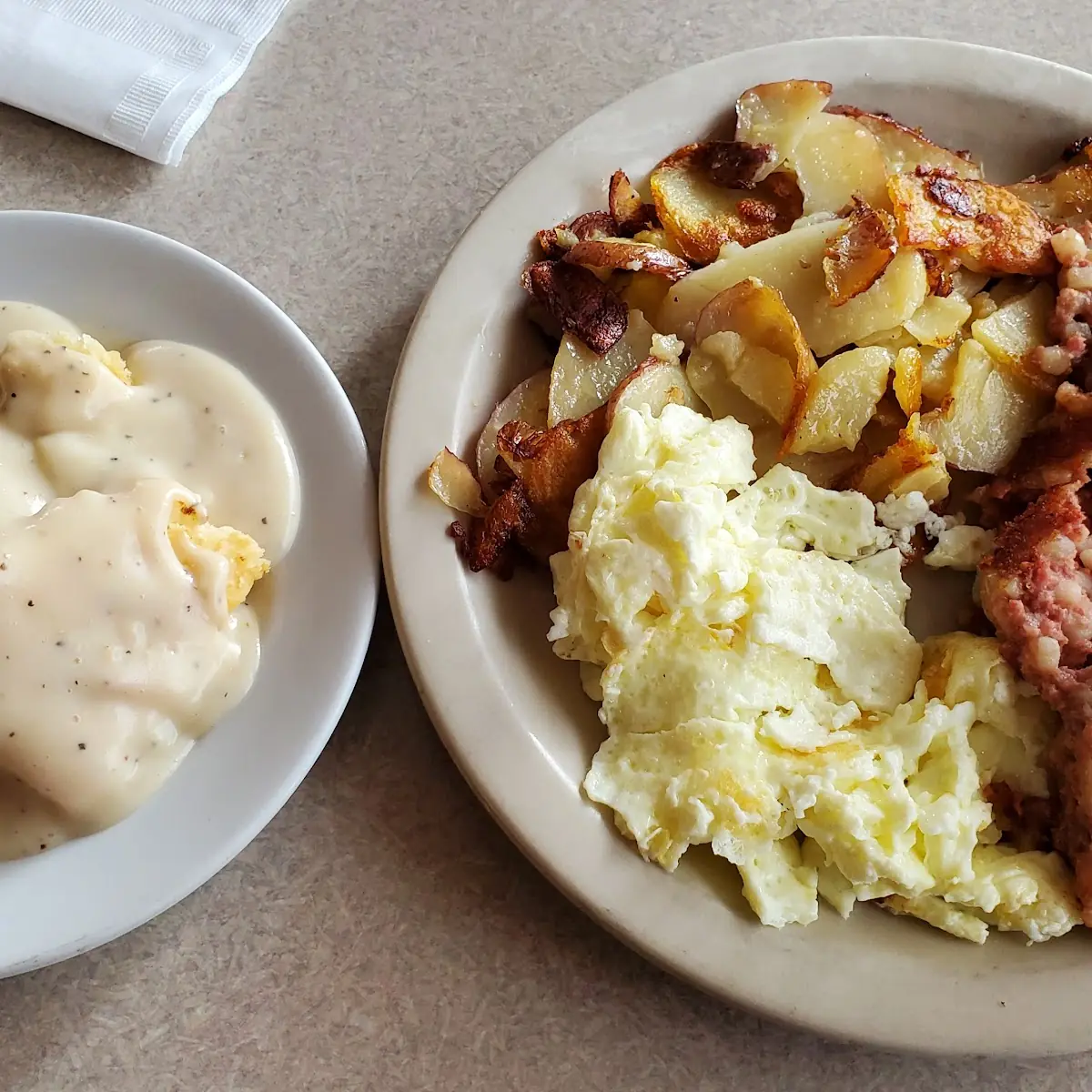 American Breakfast with Corn Beef Hash Country Potatoes and Biscuits 'N Gravy