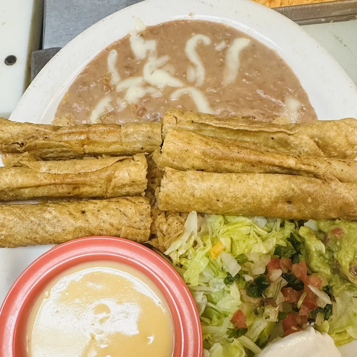 Flautas Dinner Beef or Chicken with Cheese Lettuce Tomatoes Guacamole & Sour Cream