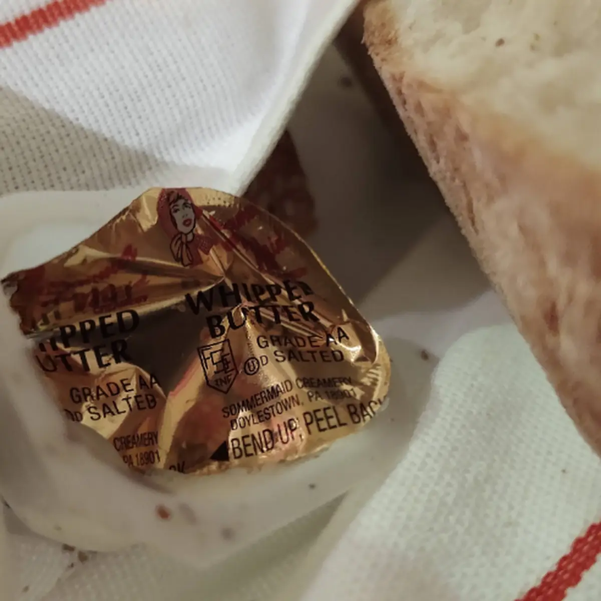 Old Used Butter Packet in Bread Basket
