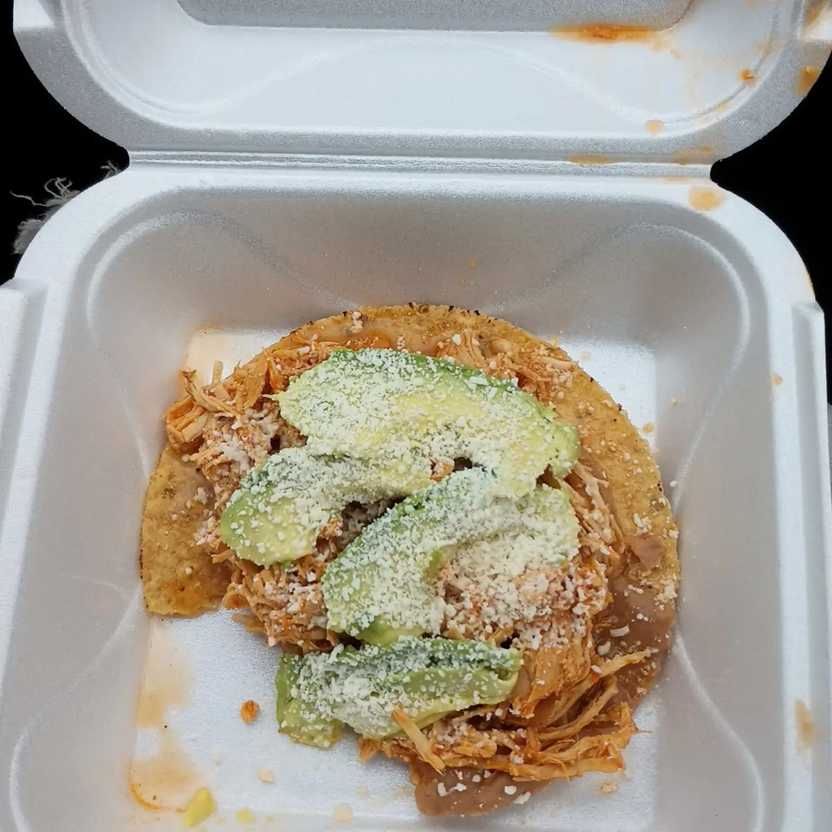 Tostada with Refried Beans Lettuce Tomato and Avocado