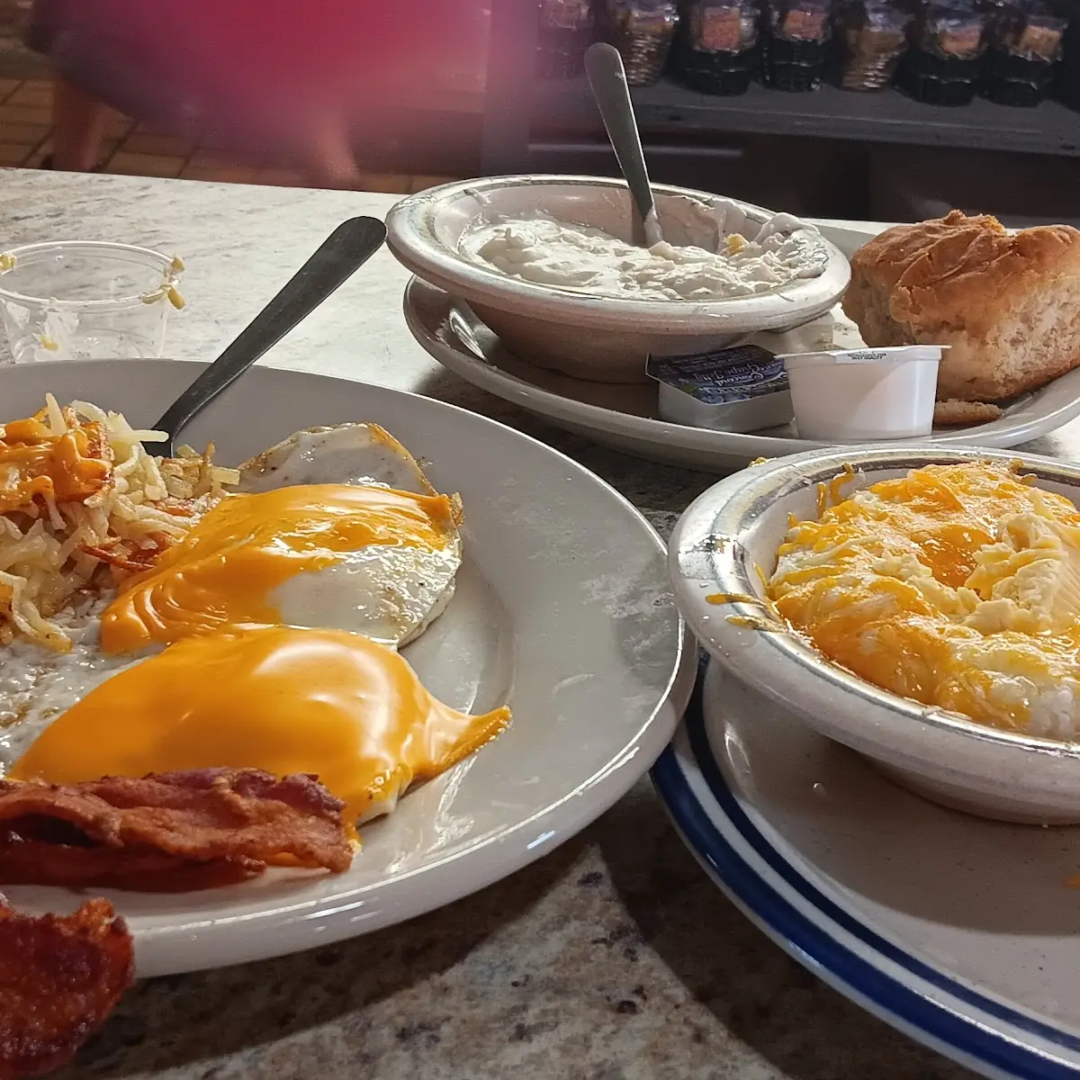 Crispy Hash Browns Cheddar Cheese Eggs Fried over Medium Cheese Grits and Biscuits and Gravy