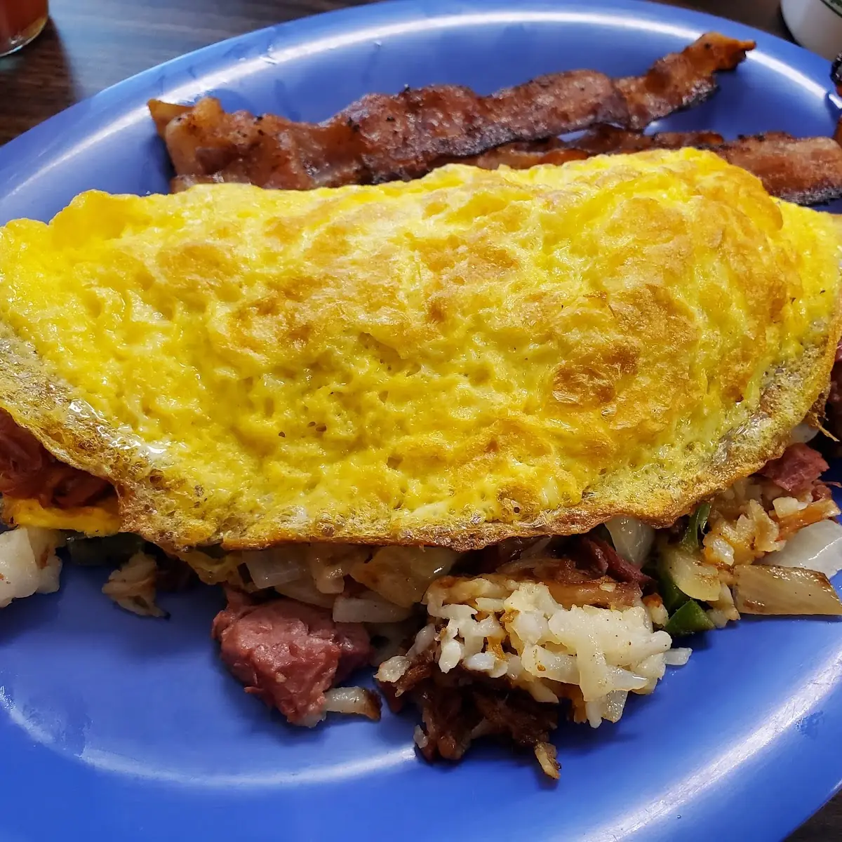 Corned Beef Hash Omelet and Side of Bacon