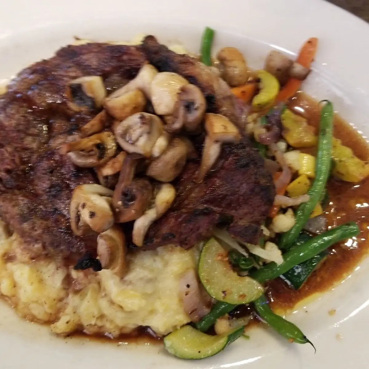 Rib Eye Steak over Mashed Potatoes and Vegetables