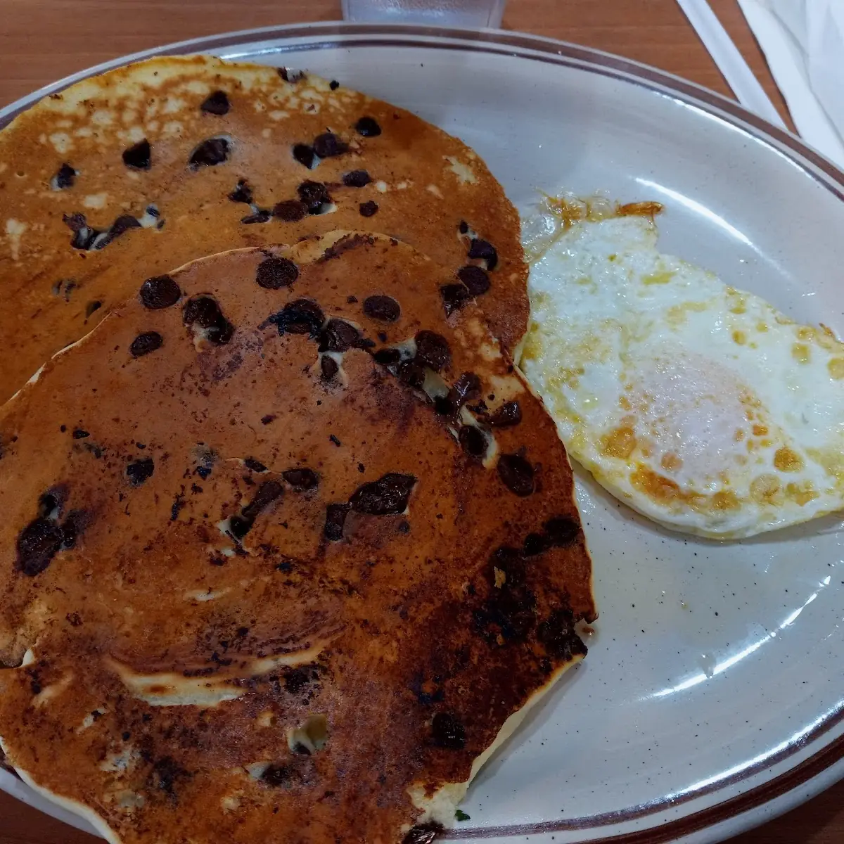 Chocolate Chip Pancakes and over Easy Egg